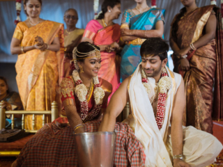Young couple enjoying Traditional Ring Finding Game in brahmin wedding