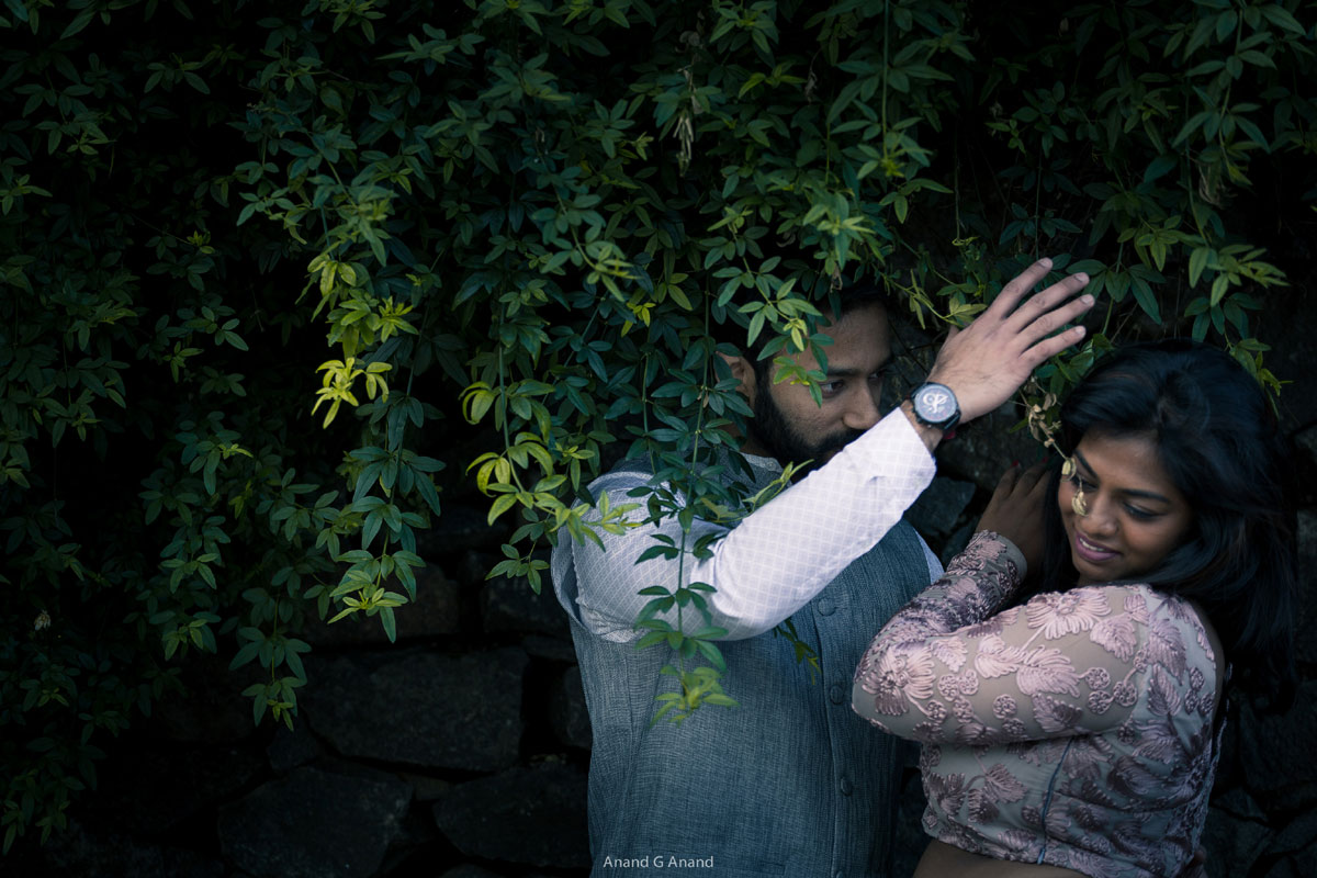 A lovely pre-wedding photoshoot of a romantic couple at green tree background